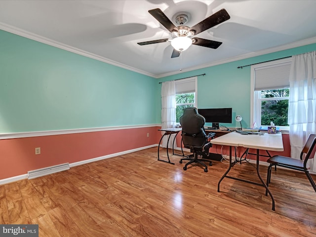 home office with baseboards, visible vents, ceiling fan, wood finished floors, and crown molding