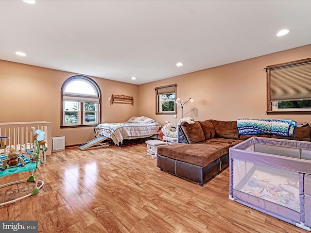 bedroom with wood finished floors and recessed lighting