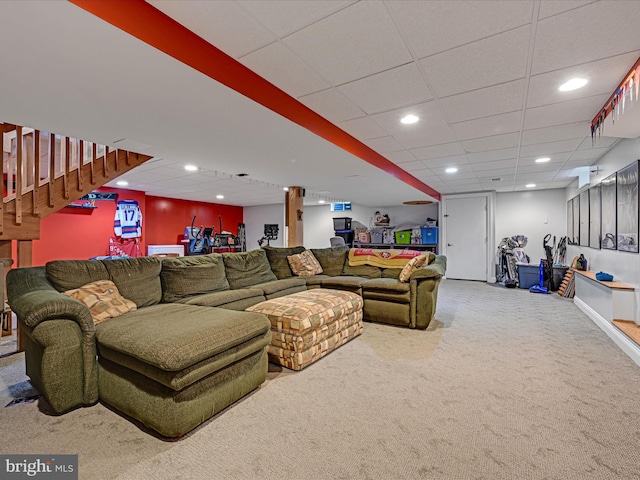 living room with carpet floors, recessed lighting, a drop ceiling, and stairs