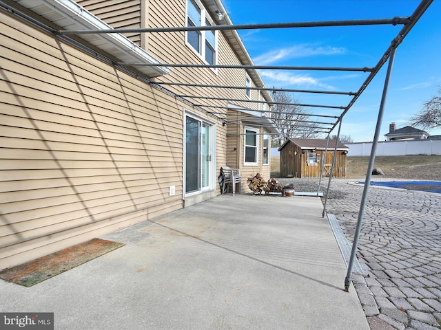 view of patio with a storage unit and an outdoor structure