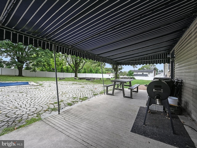 exterior space with outdoor dining space, fence, and a wooden deck