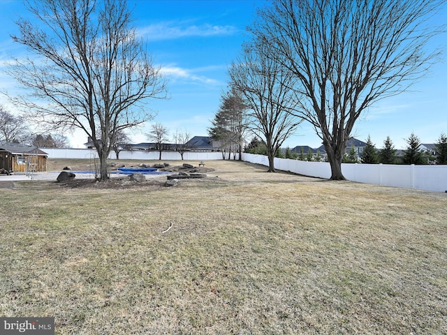 view of yard with a water view and fence