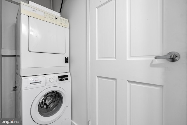 laundry room with stacked washer and dryer and laundry area