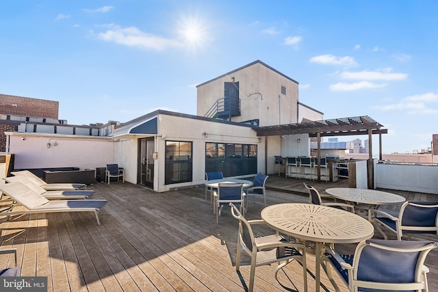 wooden terrace with outdoor dining area and a pergola