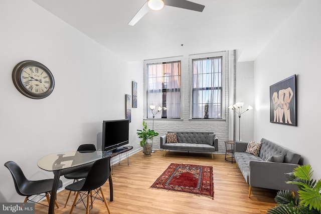 living room with ceiling fan and wood finished floors