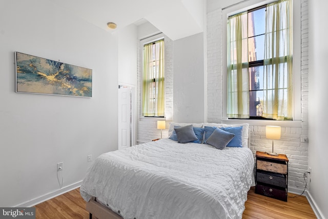 bedroom with baseboards and wood finished floors