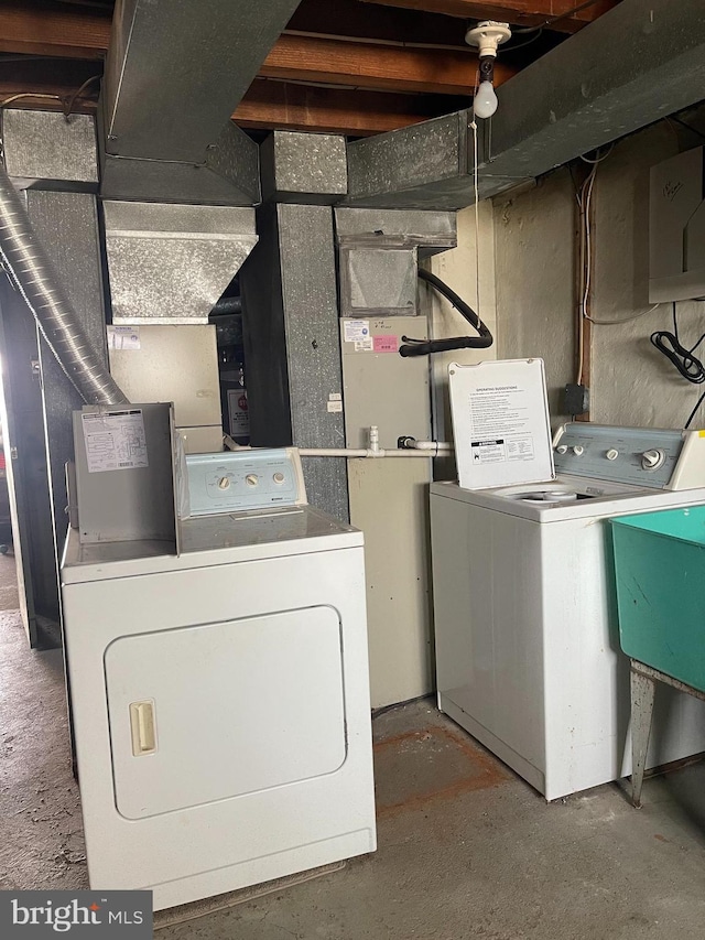 washroom featuring washer and dryer, laundry area, and a sink