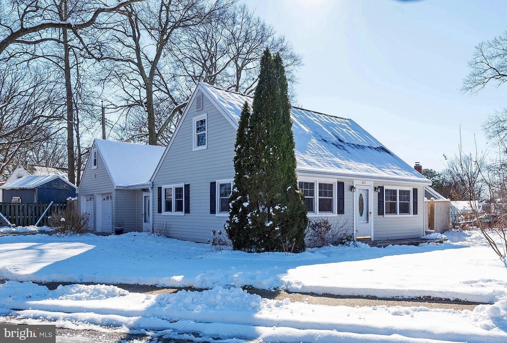 view of front of home with a garage and fence