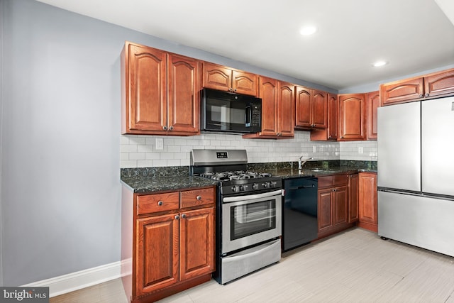 kitchen featuring black appliances, dark stone countertops, backsplash, and a sink