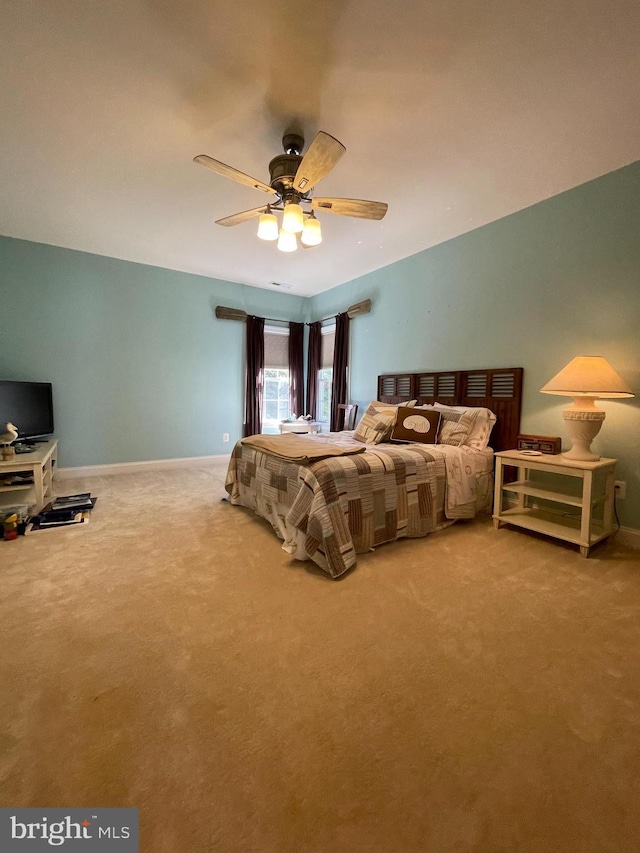 bedroom featuring carpet, baseboards, and a ceiling fan