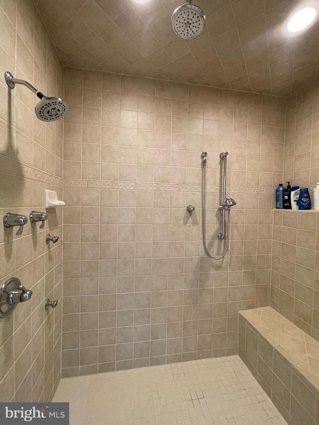 full bath featuring a tile shower