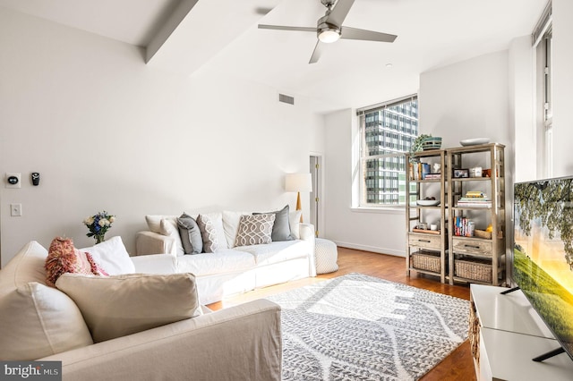 living area featuring ceiling fan, visible vents, and wood finished floors