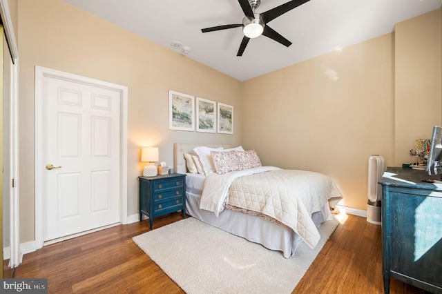 bedroom featuring a ceiling fan, wood finished floors, and baseboards