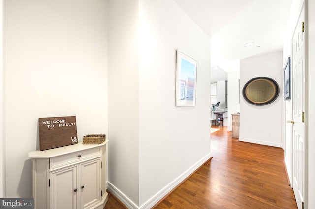 hall with wood finished floors and baseboards