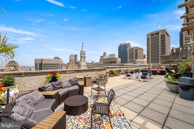 view of patio featuring an outdoor hangout area and a city view