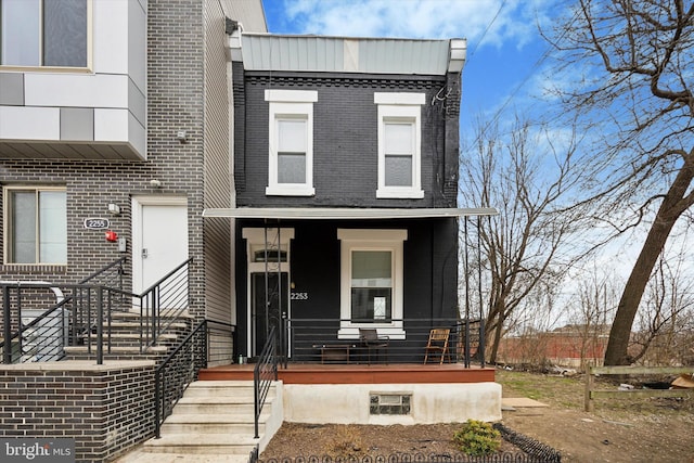 multi unit property with brick siding and covered porch