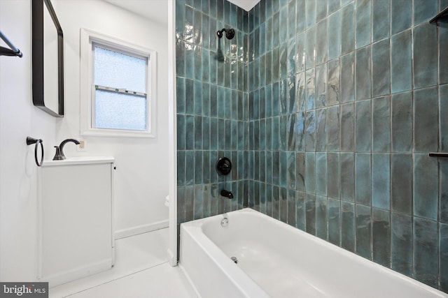 full bathroom featuring tile patterned floors, baseboards, vanity, and washtub / shower combination