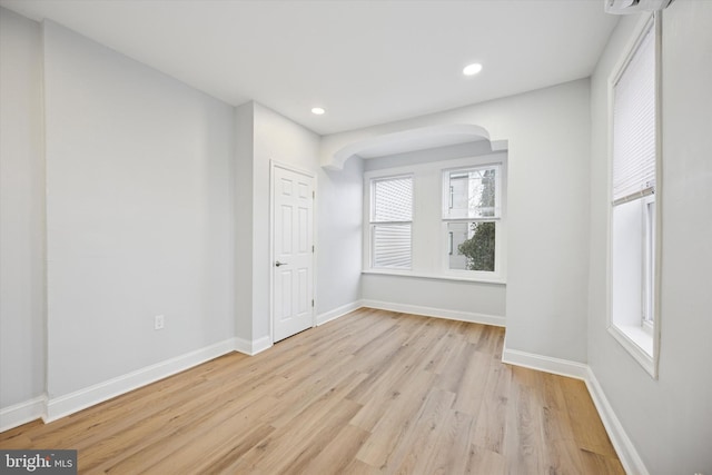 unfurnished room featuring light wood-style flooring, recessed lighting, and baseboards