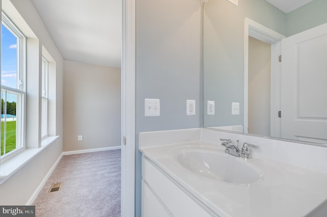 bathroom with visible vents, vanity, and baseboards