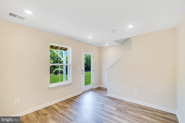 unfurnished room with baseboards, visible vents, wood finished floors, and recessed lighting