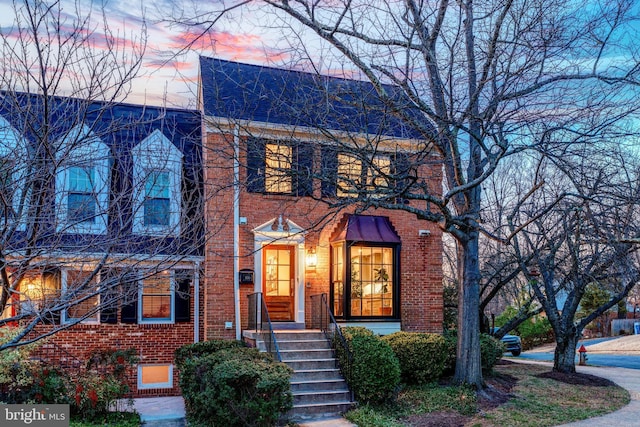 view of front of home featuring brick siding