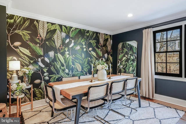 dining area featuring baseboards, wallpapered walls, wood finished floors, and crown molding