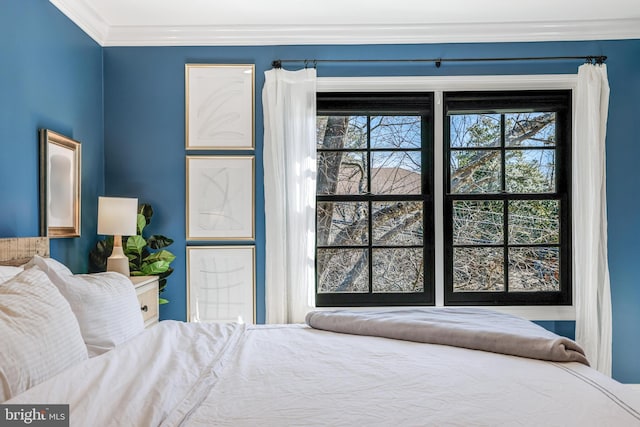 bedroom featuring multiple windows and crown molding