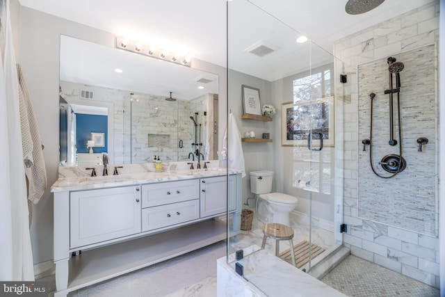 bathroom featuring double vanity, a stall shower, a sink, and visible vents