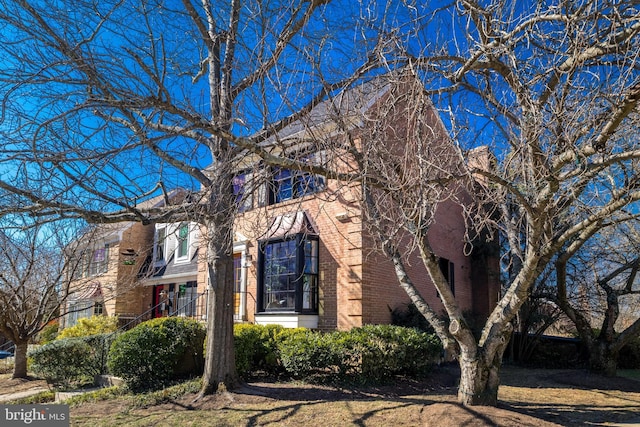 view of side of home featuring brick siding