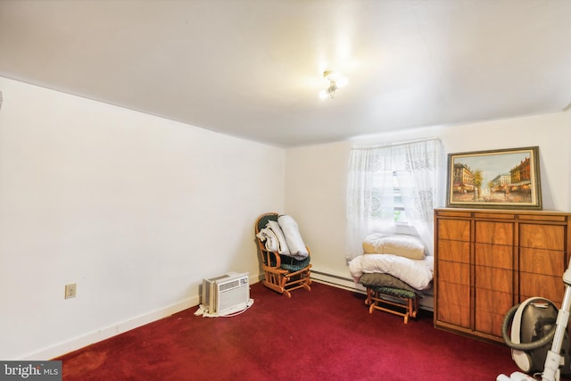 sitting room with a baseboard heating unit, baseboards, and carpet flooring