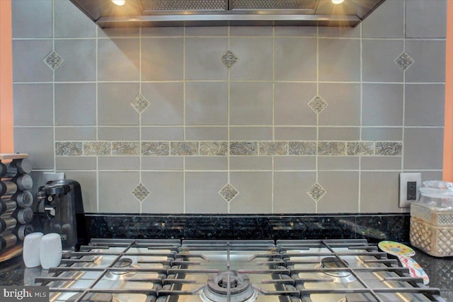 interior details with stainless steel gas stovetop and backsplash