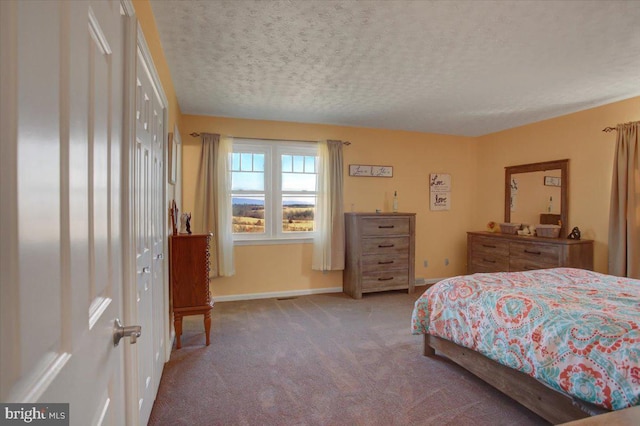 bedroom featuring carpet, a textured ceiling, and baseboards