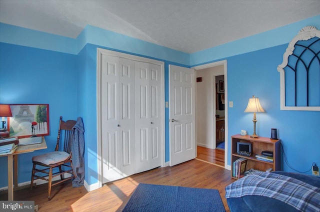 interior space with wood finished floors and baseboards