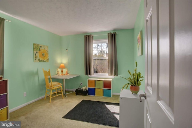 game room with carpet flooring, a textured ceiling, and baseboards