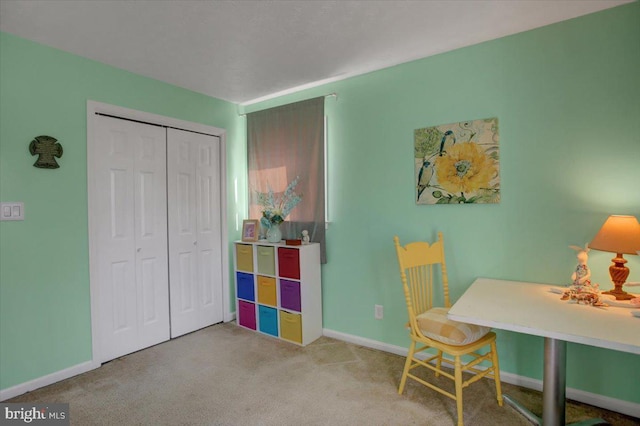 office space featuring carpet floors and baseboards