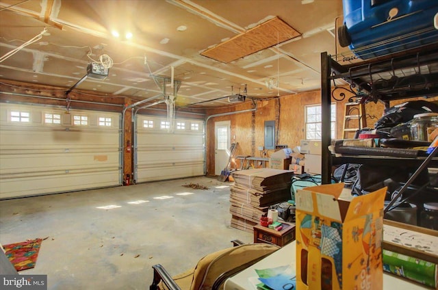 garage featuring electric panel and a garage door opener