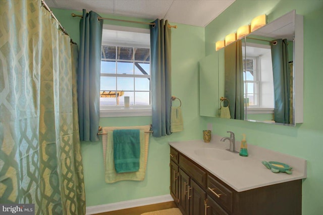 bathroom with vanity and baseboards