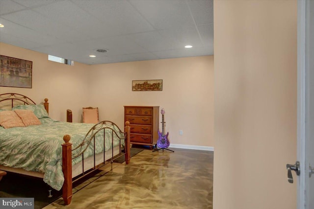 bedroom with a paneled ceiling, recessed lighting, visible vents, concrete flooring, and baseboards