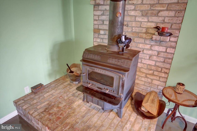 details with wood finished floors, a wood stove, and baseboards