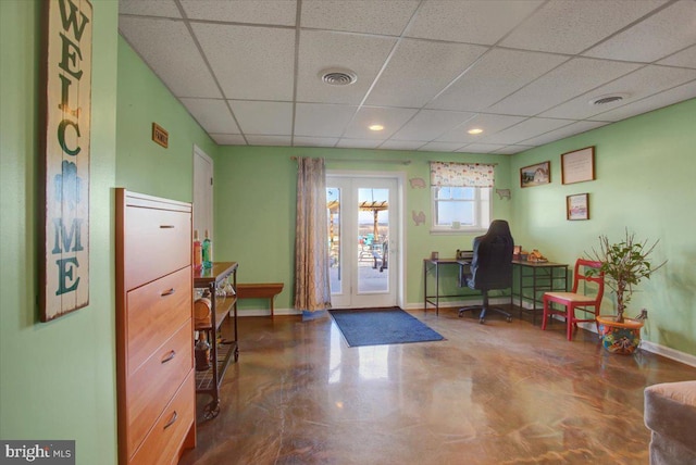 interior space featuring a paneled ceiling, visible vents, and baseboards