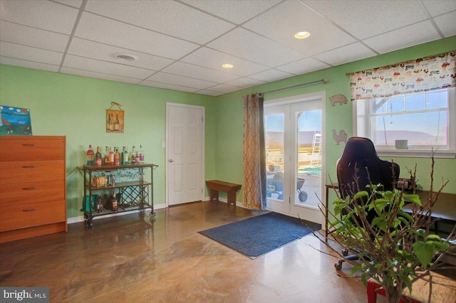 doorway with a paneled ceiling, visible vents, baseboards, and recessed lighting