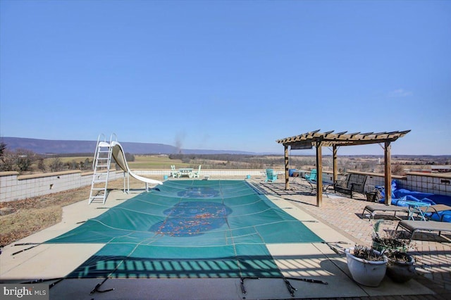 view of pool with a mountain view, a patio, and a pergola