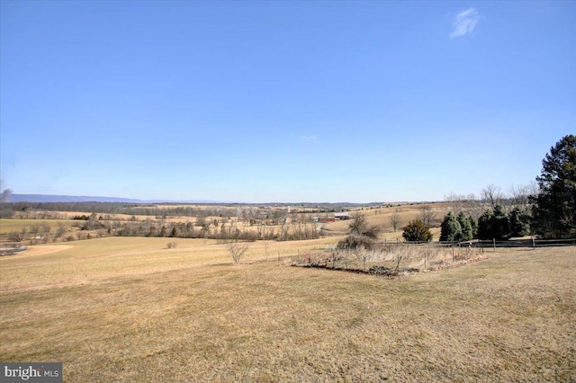 exterior space featuring fence and a rural view