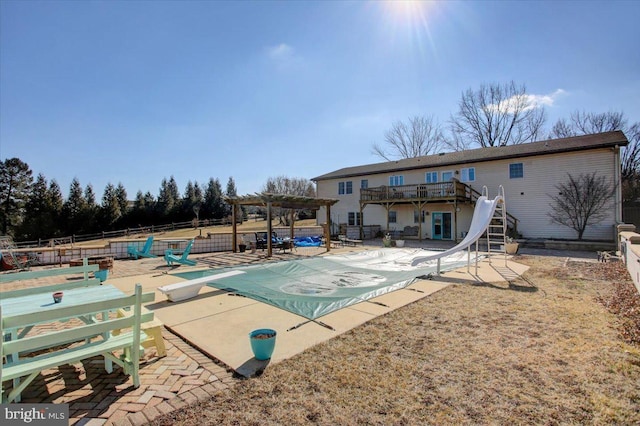 view of swimming pool with stairway, a patio area, a pergola, a water slide, and a diving board