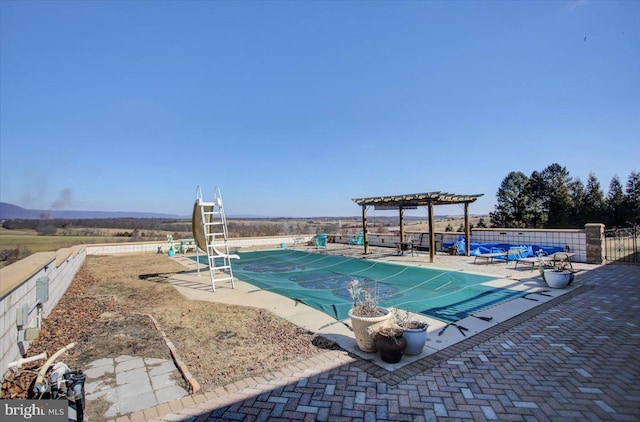 view of pool featuring a water slide, fence, and a pergola