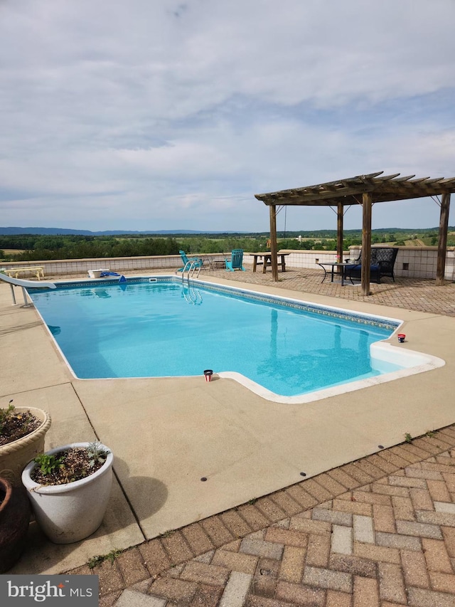 view of swimming pool with fence, a diving board, a fenced in pool, a pergola, and a patio area