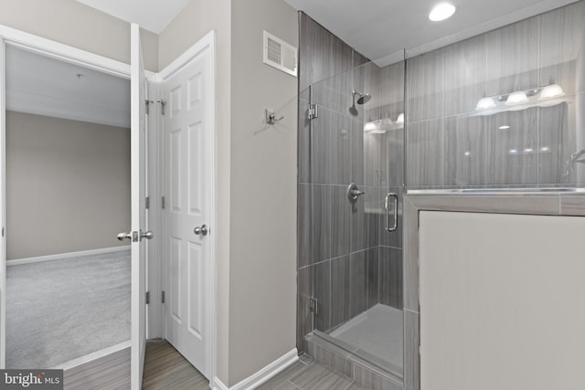 full bath with visible vents, a stall shower, and baseboards