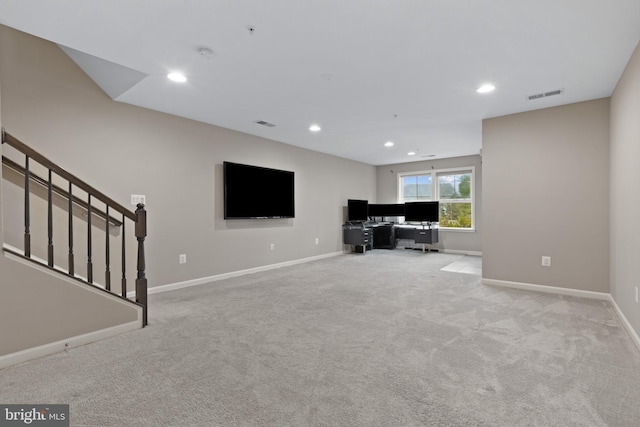 unfurnished living room with visible vents, recessed lighting, carpet floors, baseboards, and stairs