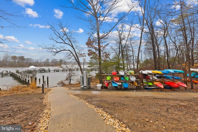 exterior space featuring a dock and a water view