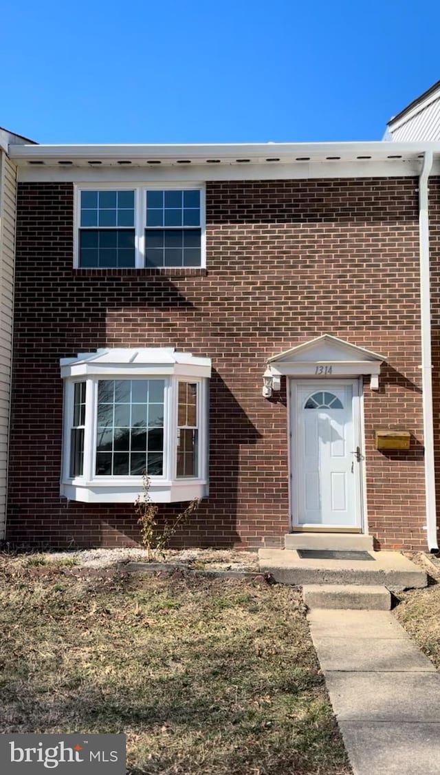 property entrance with brick siding